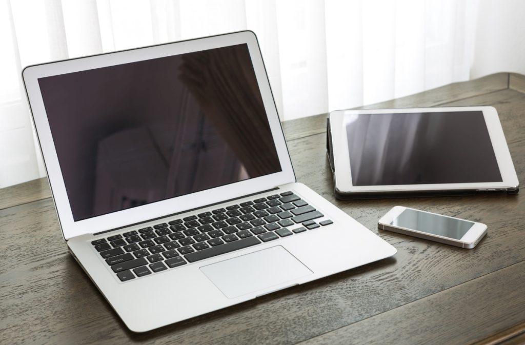 laptop with tablet and smart phone on table